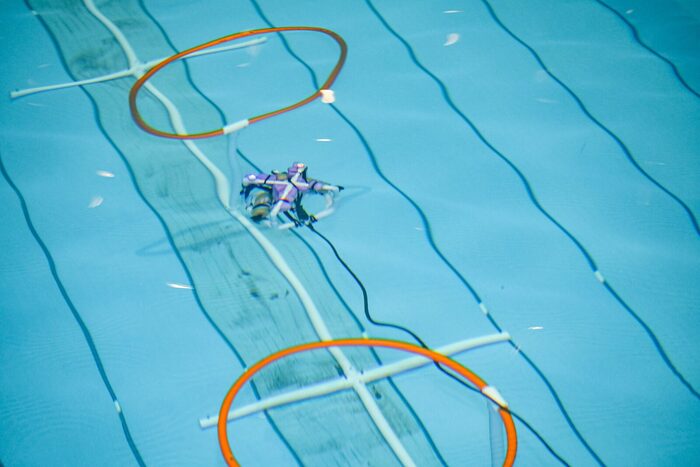 A SeaPerch vehicle passing through a hoop on the obstacle course
