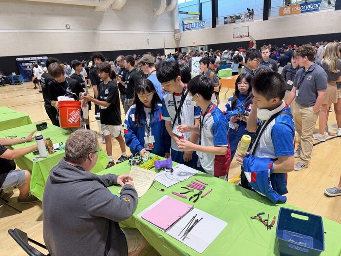 Students presenting their vehicle to judges at the inspection table